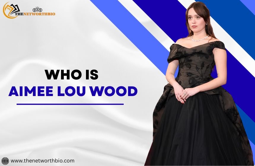 Aimee Lou Wood wearing black dress against a abstract background with who is aimee lou wood 
