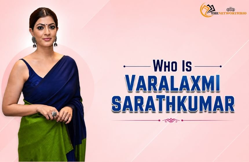 Who Is Varalaxmi Sarathkumar” graphic featuring a woman in a navy blue and green saree against a soft pink background